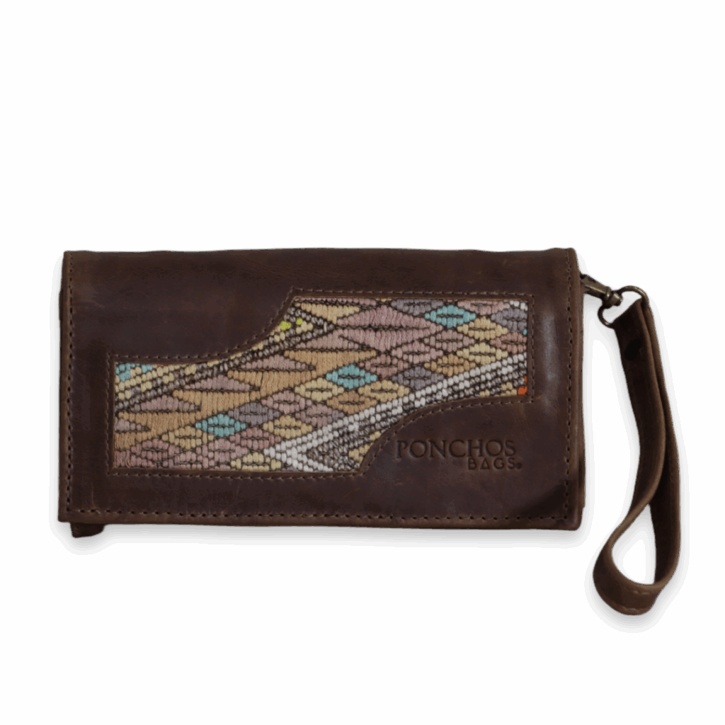 SANTO TOMÁS, a handmade leather clutch, with a huipil