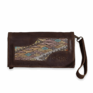 SANTO TOMÁS, a handmade leather clutch, with a huipil